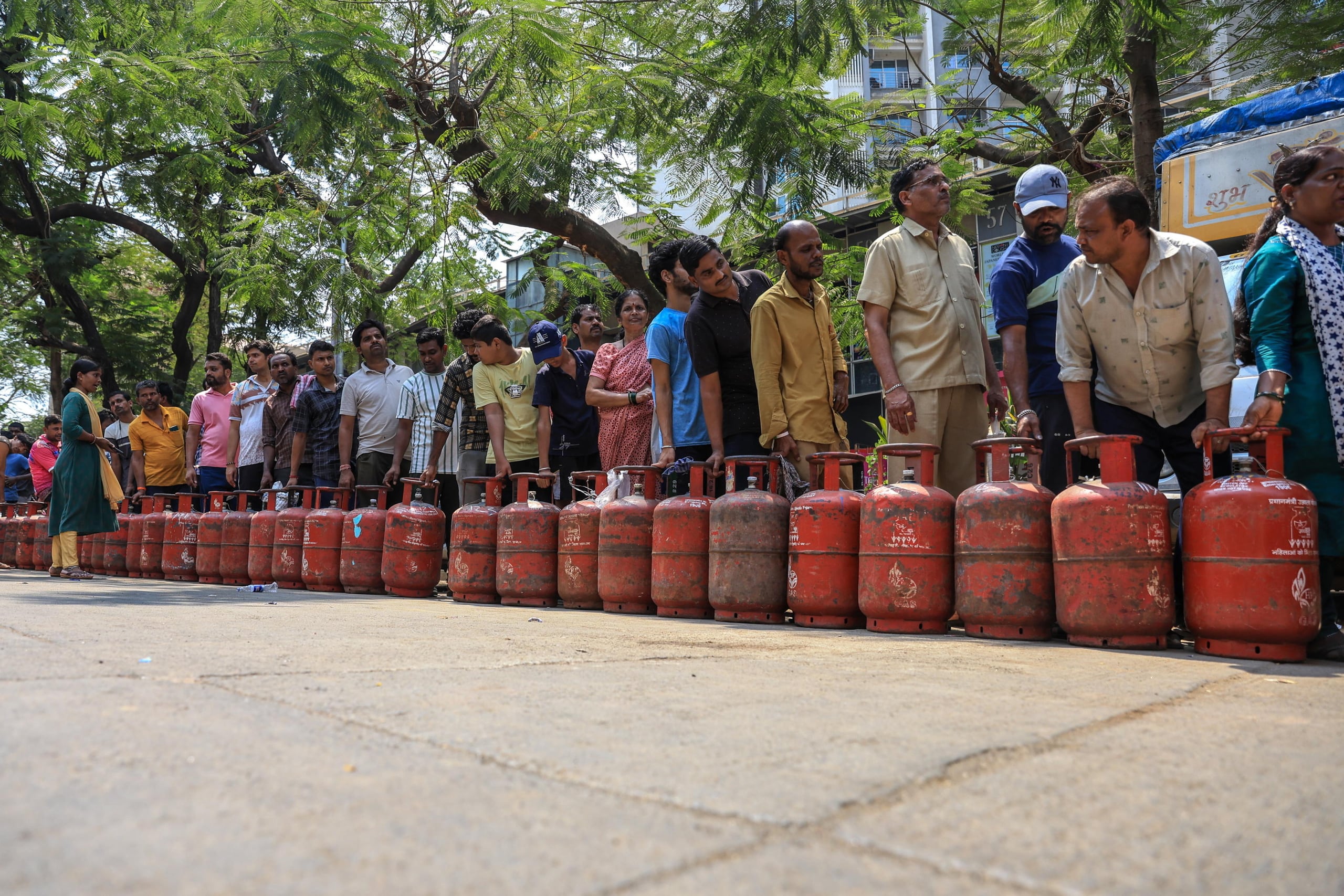In India le persone fanno la fila per riempire le proprie bombole di gas GPL vuote
